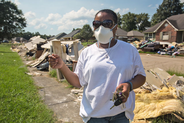 Robin Kay in front of her flood-damaged home in Monticello, Louisiana. She thinks the recently completed Central Thruway roadway project contributed to the severity of the flood. (Photo: Julie Dermansky)