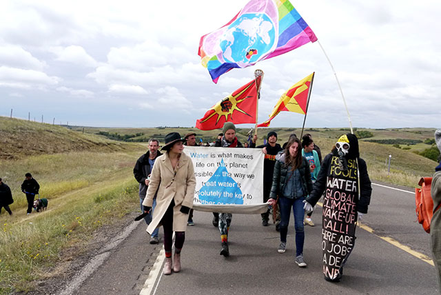 People from the Oceti Sakowin camp walking to the Dakota Access Pipeline construction site near the Missouri River, whose waters they say they are trying to protect, September 13, 2016. (Photo: Sarah Jaffe / BillMoyers.com) 