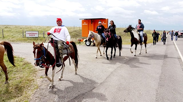 Horseback riders march from the Oceti Sakowin Camp to the Dakota Access Pipeline construction site, September 13, 2016. (Photo: Sarah Jaffe / BillMoyers.com) 