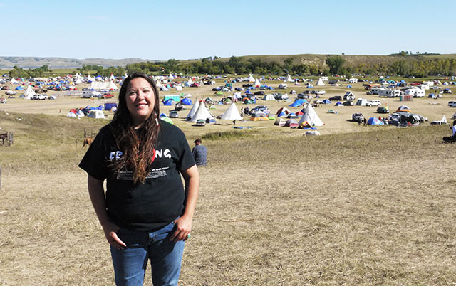 Kandi Mossett on a hill overlooking the Oceti Sakowin camp. (Photo: Sarah Jaffe / BillMoyers.com)