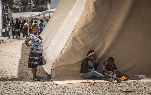 A family waits inside the Padre Chava shelter in downtown Tijuana. (Photo: Heriberto Paredes)