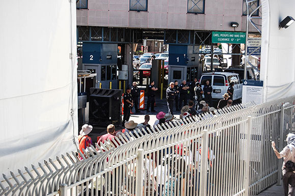 Migrants and travelers wait in line at the Nogales port of entry, the second largest Border Patrol station in the United States. (Photo: Alexa Mencia / MEDILL)