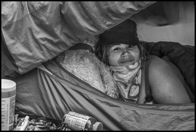 MuZiK, a resident of the occupation, in her tent in the middle of Adeline Street. (Photo: David Bacon)