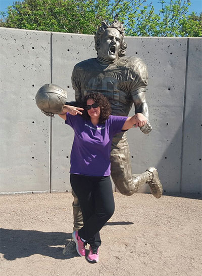 Sabrina Weller in front of Pat Tillman’s statue outside of Phoenix University Stadium. (Photo: Courtesy of Rory Fanning)