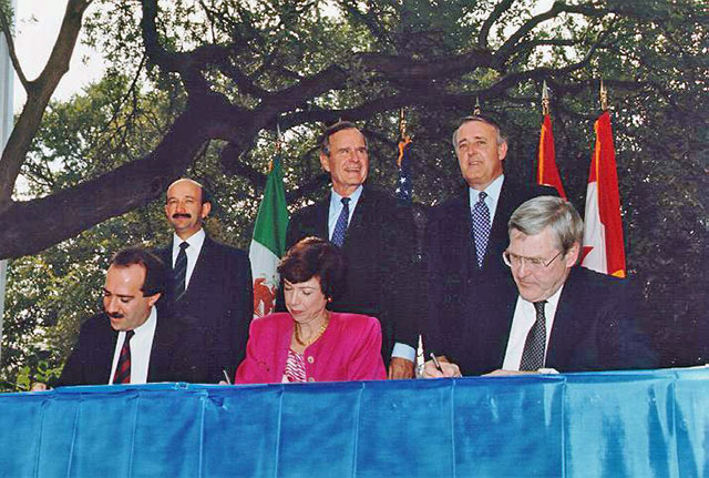 Opening Pandora's Box: NAFTA Initialing Ceremony, October 1992. From left to right (standing) Mexican President Carlos Salinas de Gortari, US President George H. W. Bush, Canadian Prime Minister Brian Mulroney. (Seated) Jaime Serra Puche, Carla Hills, Michael Wilson. NAFTA's Chapter 11 provisions unexpectedly opened the door for massive corporate lawsuits that have undermined democracy and environmental protections. (Photo courtesy of UNCTAD)