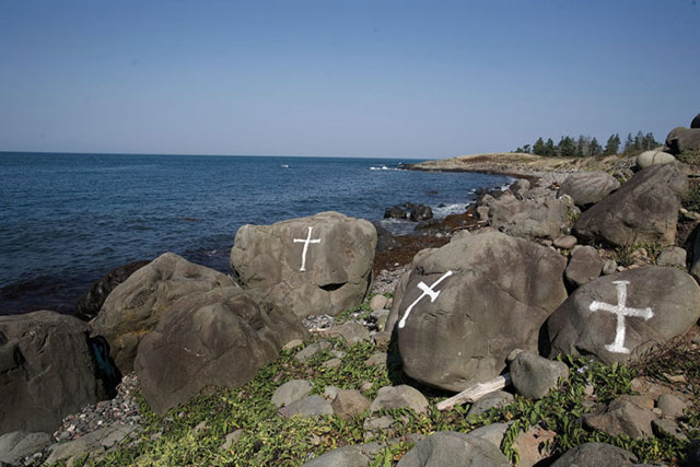 Crosses painted on rocks near the proposed Bilcon marine terminal site. The local community protested loudly against Bilcon's quarry and industrial seaport proposal. (Photo by Kemp Stanton licensed under the Creative Commons Attribution-Share Alike 2.0 generic license)