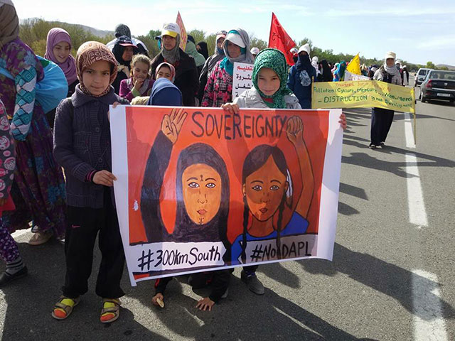 With a banner depicting their fight against the silver mining corporation Managem as a sister struggle to the fight against the Dakota Access pipeline in Standing Rock, Indigenous Amazigh people from the Moroccan town of Imider continued their protest against the mining corporation on November 20, 2016. (Photo: Nadir Bouhmouch)