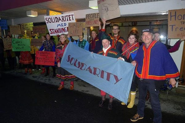 Sámi people in Tromsø, Norway hold a solidarity event on September 28, 2016. Ellen Jensen, a Sámi-American organizer, is holding the Solidarity sign on the left. (Photo: Øvind Ravna)