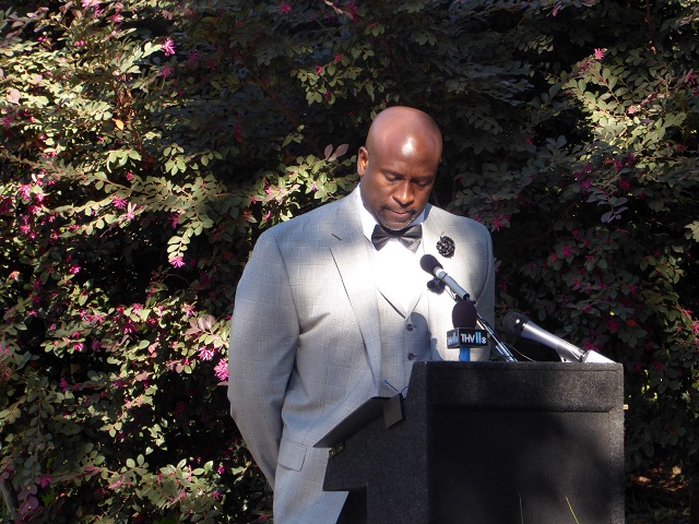 Spencer Ellison, whose unarmed father was shot to death by police officers in his own home, addresses attendees at the City of Little Rock's dedication of a public bench in memory of his father on November 4, 2016. Ellison and his brother brought a federal civil rights lawsuit and won the largest monetary settlement ever reached in a Little Rock police case, in addition to an official apology from the city. 