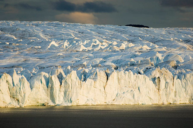 A 200 foot high ice cliff on the Russell Glacier in Greenland. Where ice sheets and glaciers terminate in water, their height is limited to 200 to 300 feet because the ice is simply too weak to hold itself up at greater heights. (Photo: Bruce Melton)