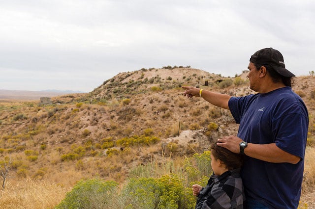 Joseph Holley of the Battle Mountain Band of the Te-Moak Western Shoshone surveys the land with his grandson, Julius. Holley's band has taken the lead in protecting the Tosawihi Quarries, a tribal sacred site in north-central Nevada, from destruction by gold mining. The Shoshone have used the Tosawihi Quarries for more than 14,000 years, going there to collect their sacred white flint, fashion it into weapons, and use it in ceremonies. (Photo: Joseph Zummo)