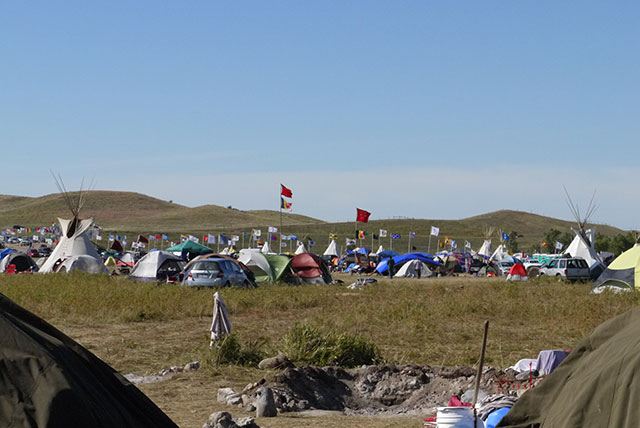 Water Protectors pitch tents at the Oceti Sakowin Camp along the Cannonball River at Standing Rock in September 2016. (Photo: Sarah Jaffe)