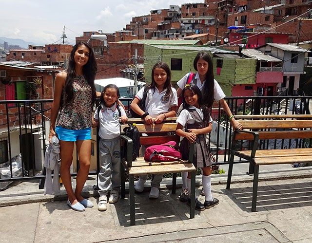 Milena Palacio, founder of the Stairway to English project in Medellín, Colombia, poses with schoolchildren in Comuna 13, the at risk barrio where she teaches English. (Photo: Michael Meurer)