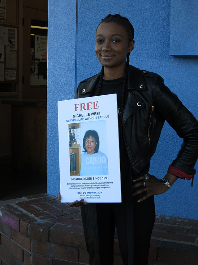 Miquelle West holds a photo of her mother, Michelle West, Los Angeles, 2016. (Photo: Victoria Law)