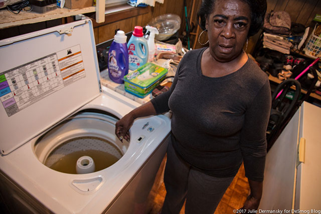 St. Joseph resident Rudy Shorts fills her washing machine to see if the water is usable and opts not to use it. (Photo: Julie Dermansky)