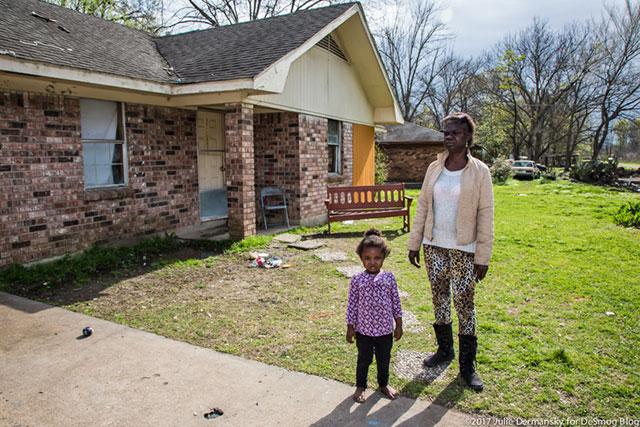 Maxine Washington, here with one of her grandchildren, wishes the tanks providing clean water were closer to her home. (Photo: Julie Dermansky)