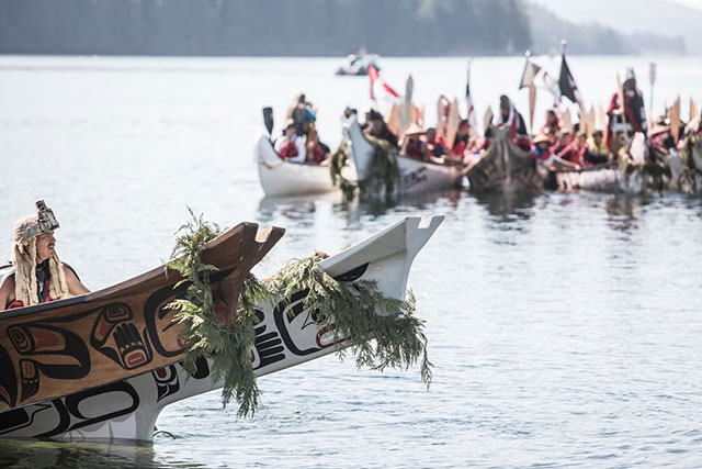 Traditional canoes arrive at Point Grenville, near Taholah, as part of an annual inter-tribal festival celebrating Native history, culture, and tradition. For many tribes, losing home can also mean losing touch with vital cultural and spiritual practices. (Photo: Kris Krüg)