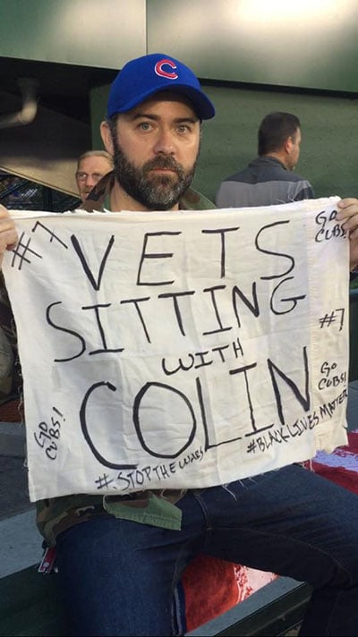 Rory Fanning sits in solidarity with Colin Kaepernick at a Chicago Cubs baseball game in 2016. (Photo: Courtesy of Rory Fanning)