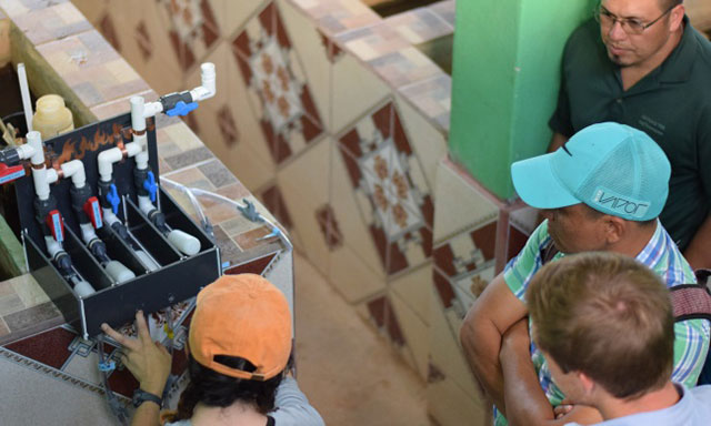 Students work with plant operators in Honduras. (Photo courtesy of AguaClara)