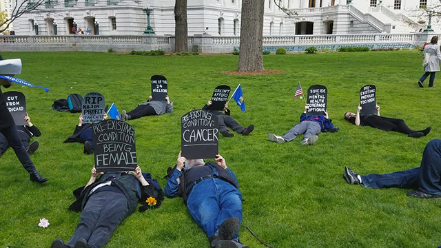 Indivisible Pasco greets Rep. Gus Bilirakis with a die-in at his new office opening. (Photo: Indivisible)