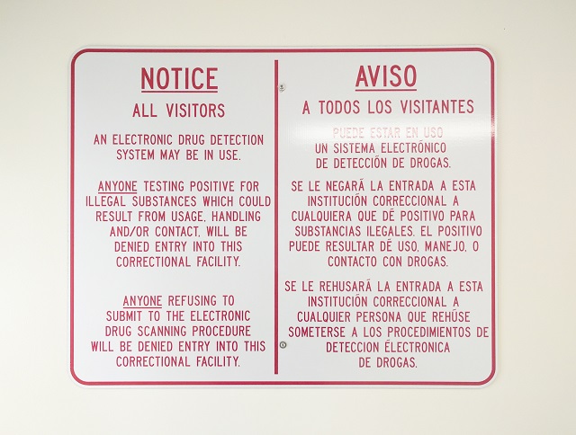 A sign hanging in the entrance to Altona's visitor center lays out the rules for drug dectection scans at the facility. (Photo: Ese Olumhense)