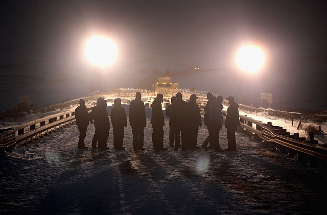 Military veterans confront police guarding a bridge near Oceti Sakowin Camp on the edge of the Standing Rock Sioux Reservation on December 1, 2016, outside Cannon Ball, North Dakota. TigerSwan, the mercenary firm under fire for using counterterrorism tactics against water protectors opposing the Dakota Access pipeline, has applied for a license to provide private security in Louisiana. (Photo: Echinophoria / Getty Images) 