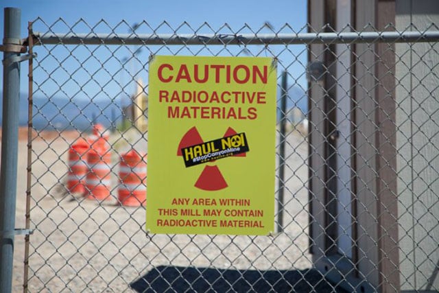 Signage at the White Mesa Mill warning of radioactive materials. (Photo: Garet Bleir)