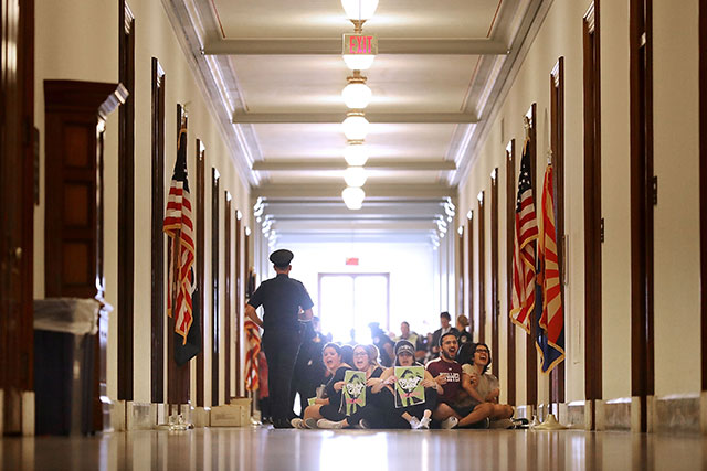 Demonstrators from Arizona chant, 'Kill the bill or lose your job' while sitting on the floor outside the offices of Sen. Jeff Flake (R-AZ) during a protest against health care reform legislation in the Russell Senate Office Building on Capitol Hill July 10, 2017 in Washington, DC. (Photo: Chip Somodevilla / Getty Images)