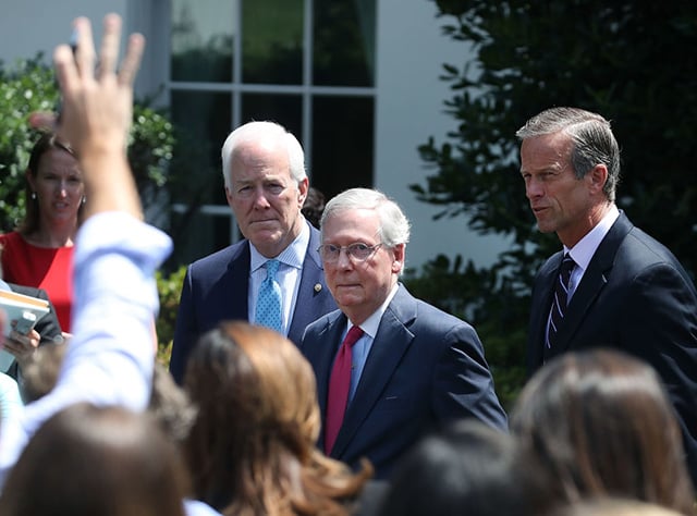 Senate Majority Leader Mitch McConnell (center), Sen. John Thune (right), and Sen. John Cornyn, speak to the media July 19, 2017 at the White House in Washington, DC. The senators met with President Donald Trump to discuss the Republican healthcare bill. (Photo: Mark Wilson / Getty Images)