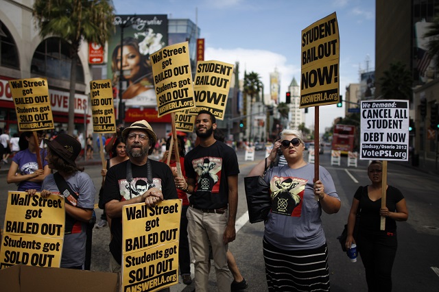 Students protest the rising costs of student loans for higher education on Hollywood Boulevard on September 22, 2012 in the Hollywood section of Los Angeles, California. Citing bank bailouts, the protesters called for student debt cancelations. (Photo by David McNew/Getty Images)