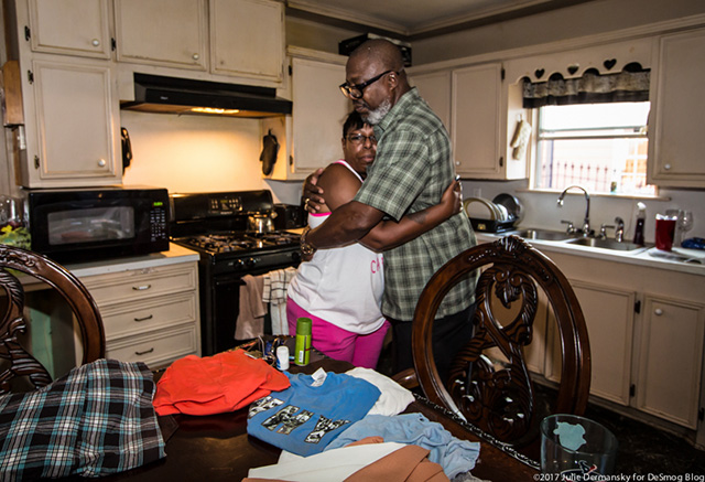 The Kelleys embrace after facing the damage left behind in the aftermath of Hurricane Harvey, which damaged their home and restaurant. (Photo: Julie Dermansky)