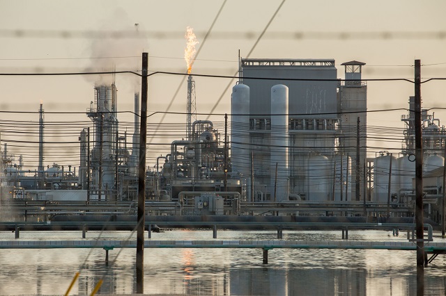 A flare erupts from a tower at a flooded refinery in Port Arthur, Texas last weekend. Damaged refineries and chemical plants released thousands of pounds of toxic pollution after Hurricane Harvey, but that did not keep House Republicans from working to gut environmental protections this week, including a program that assesses the dangers of hazardous chemicals. (Photo: Alex Glustrum) 