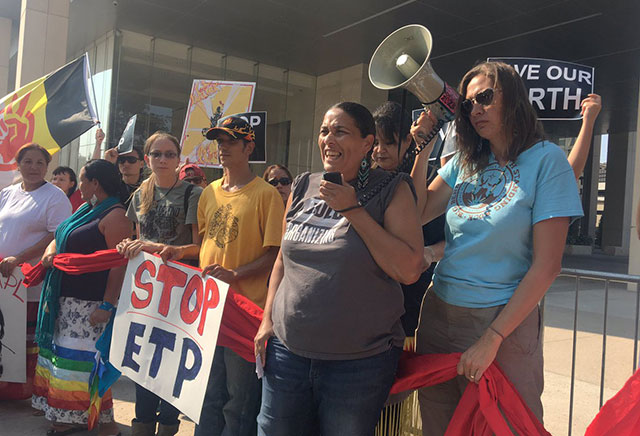 Louisiana-based organizer Cherri Foytlin addresses a crowd of protesters at Energy Transfer Partners corporate headquarters in Dallas, Texas, on Friday. Indigenous and environmental activists from across the country demonstrated against the company's pipeline projects, including the Bayou Bridge Pipeline, which would carry oil from east Texas across the sensitive wetlands of southern Louisiana. (Photo: Ethan Buckner / Earthworks)
