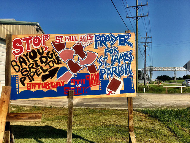 A wooden signs announces a prayer service against the Bayou Bridge Pipeline at St. Paul Baptist Church in rural St. James Parish, Louisiana, where local pastors say, 