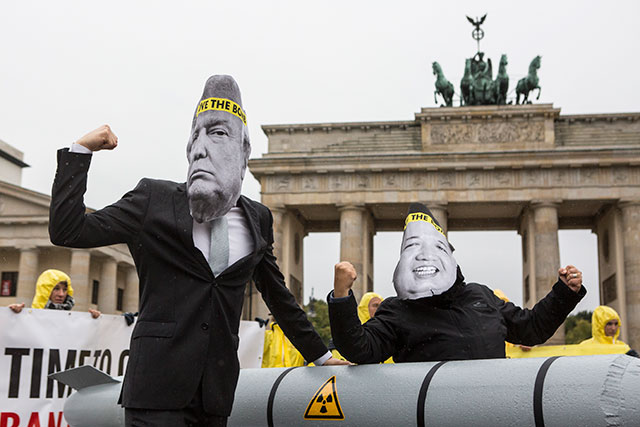 Activists wearing masks to look like US President Donald Trump and North Korean Kim Jong-Un pose next to a Styrofoam effigy of a nuclear bomb while protesting in front of the Brandenburg Gate near the American Embassy on September 13, 2017 in Berlin, Germany. The Senate has approved a massive defense bill authorizing increased spending on the US nuclear arsenal. (Photo: Omer Messinger / Getty Images)