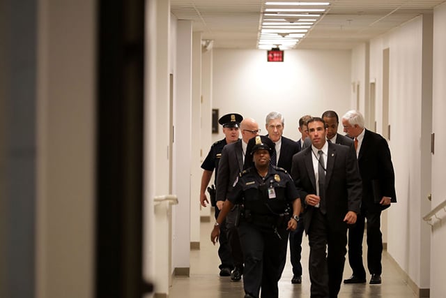 Former FBI Director Robert Mueller (center) is surrounded by security and staff as he leaves a meeting with senators at the U.S. Capitol June 21, 2017 in Washington, DC. Special Counsel overseeing the investigation into Russian interference in the 2016 presidential elections, Mueller was on Captiol Hill to meet with members of the Senate Judiciary Committee. (Photo: Chip Somodevilla / Getty Images)