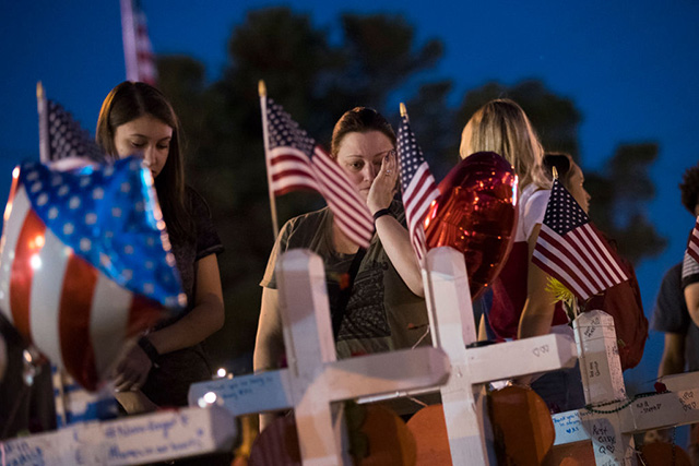 A woman pauses at a makeshift memorial on the south end of the Las Vegas Strip, October 6, 2017, in Las Vegas, Nevada. On October 1, Stephen Paddock opened fire on the crowd at the Route 91 Harvest country music festival, killing 58 people and injuring more than 450. (Photo: Drew Angerer / Getty Images)