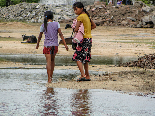Girls walk between debris in Ixtaltepec. (Photo: Renata Bessi)