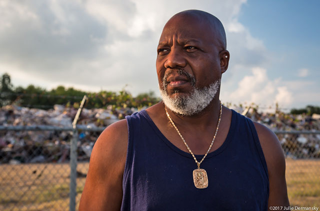 Hilton Kelley in front of the temporary dumpsite on 19th Street in Port Arthur, Texas. (Photo: Julie Dermansky)