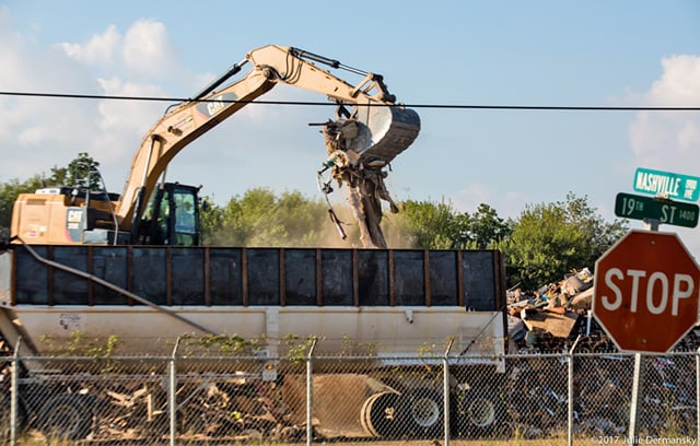 Dust in the air as debris at a temporary dumpsite on 19th Street in Port Arthur, Texas, is sorted. (Photo: Julie Dermansky)