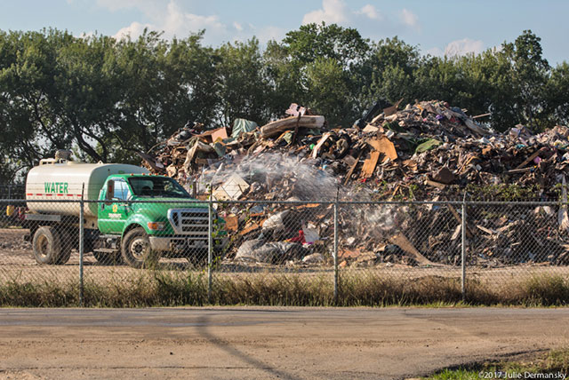 Truck spraying water to mitigate dust particles in the air at a temporary dumpsite on 19th Street in Port Arthur, Texas. (Photo: Julie Dermansky)
