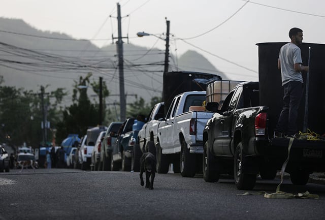 People wait in their cars in line to collect water nearly one month after Hurricane Maria struck on October 19, 2017 in San Pedro, Puerto Rico. Those in line said the wait to collect water was about two hours. Puerto Rico is suffering shortages of food and water in areas with only 21.6 percent of grid electricity and 71.58 percent of running water restored. Puerto Rico experienced widespread damage including most of the electrical, gas and water grid as well as agriculture after Hurricane Maria, a category 4 hurricane, swept through. (Photo: Mario Tama / Getty Images)