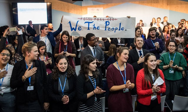 Activists disrupt an event titled: 'The Role of Cleaner and More Efficient Fossil Fuels and Nuclear Power in Climate Mitigation' with friendly singing at the COP 23 United Nations Climate Change Conference on November 13, 2017 in Bonn, Germany. (Photo: Lukas Schulze / Getty Images)