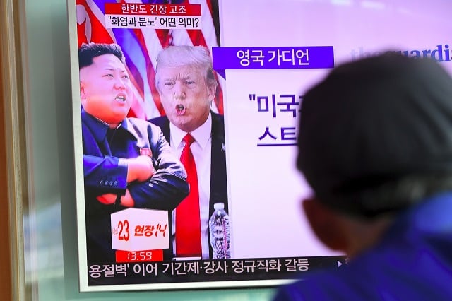 A man watches a television news programme showing US President Donald Trump (C) and North Korean leader Kim Jong-Un (L) at a railway station in Seoul on August 9, 2017. President Donald Trump issued an apocalyptic warning to North Korea on Tuesday, saying it faces 'fire and fury' over its missile program, after US media reported Pyongyang has successfully miniaturized a nuclear warhead. (Photo: JUNG YEON-JE/AFP/Getty Images)