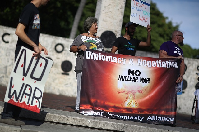 Protesters gather to ask President Donald Trump to stop his drive to war against North Korea on August 14, 2017 in Miami, Florida. The protesters feel that President Trump's rhetoric has created the threat of a devastating nuclear war for the first time since the Cuban missle crisis. (Photo by Joe Raedle/Getty Images)
