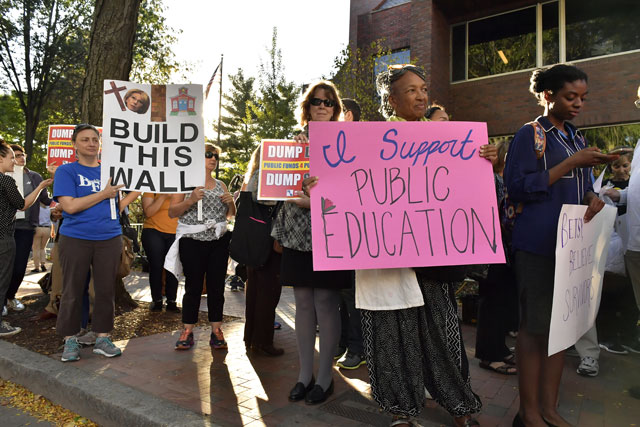 Protestors demonstrate as Education Secretary Betsy DeVos speaks at the Harvard University John F. Kennedy Jr. Forum on 'A Conversation On Empowering Parents' on September 28, 2017 in Cambridge, Massachusetts. DeVos was met by protestors both outside the venue and inside during her remarks. (Photo: Paul Marotta / Getty Images)