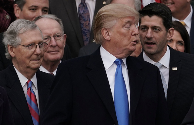 Speaker of the House Rep. Paul Ryan talks to Donald Trump as Senate Majority Leader Sen. Mitch McConnell and Sen. Lamar Alexander look on during an event to celebrate Congress passing the Tax Cuts and Jobs Act with Republican members of the House and Senate on the South Lawn of the White House December 20, 2017, in Washington, DC. (Photo: Alex Wong / Getty Images)