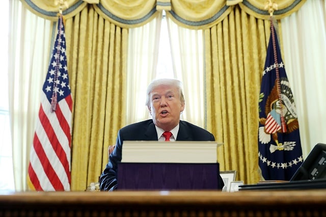 President Donald Trump talks with journalists after signing tax reform legislation into law in the Oval Office December 22, 2017 in Washington, DC. Trump praised Republican leaders in Congress for all their work on the biggest tax overhaul in decades. (Photo by Chip Somodevilla/Getty Images)