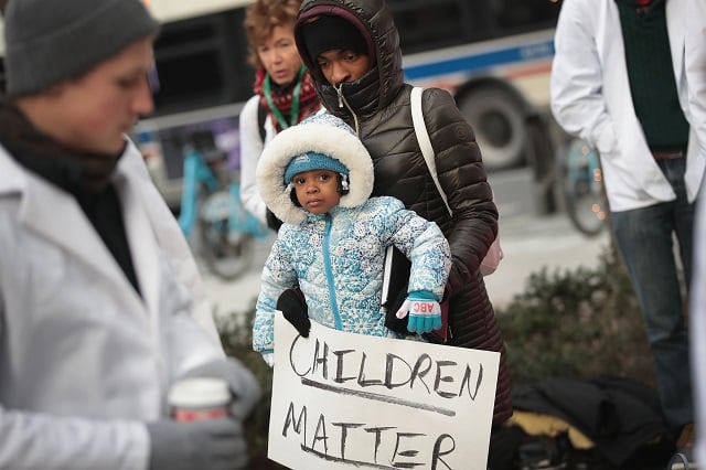 Melanie Lockridge and her 2-year-old daughter Zariyah attend a rally hosted by University of Chicago medical students to call on Congress to reauthorize funding forthe Children's Health Insurance Program (CHIP) on December 14, 2017 in Chicago, Illinois. On September 30, congress let funding for CHIP expire, leaving states to carry the burden for medical expenses of the 9 million children enrolled in the program. Lockeridge's two daughters were enrolled in the program. (Photo by Scott Olson/Getty Images)