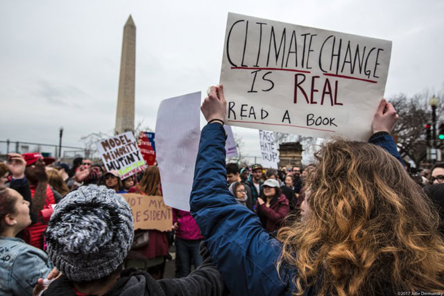 Washington, D.C. January 20, 2017. Protester with DisruptJ20 holds a sign in support of climate science at a demonstration near the National Mall during the inauguration of Donald Trump as the 45th President of the United States.